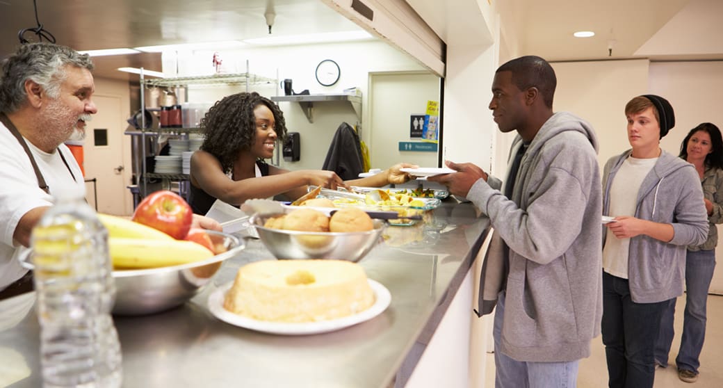 Residents in a homeless shelter get a hot meal